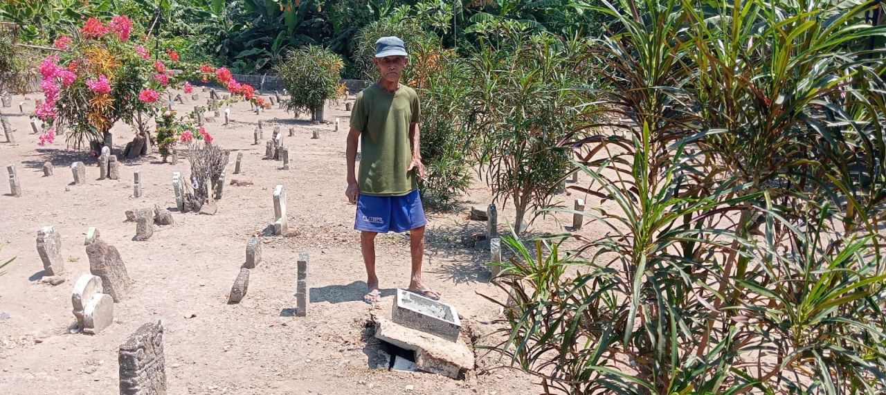 Rusak : Mbah Dun Juru Kunci makam umum dusun Besuk, saat menunjukkan salah satu batu nisan yang diduga dirusak orang tidak dikenal