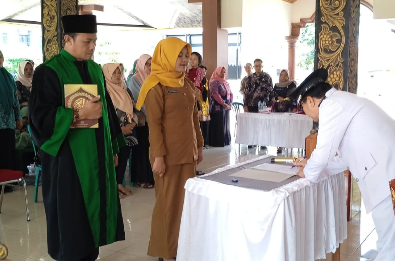 Kepala Desa Krembangan, Kusnan, menandatangani dokumen pelantikan Kepala Dusun Gempol Kerep (foto : sulistyowati_beritaformat.com)