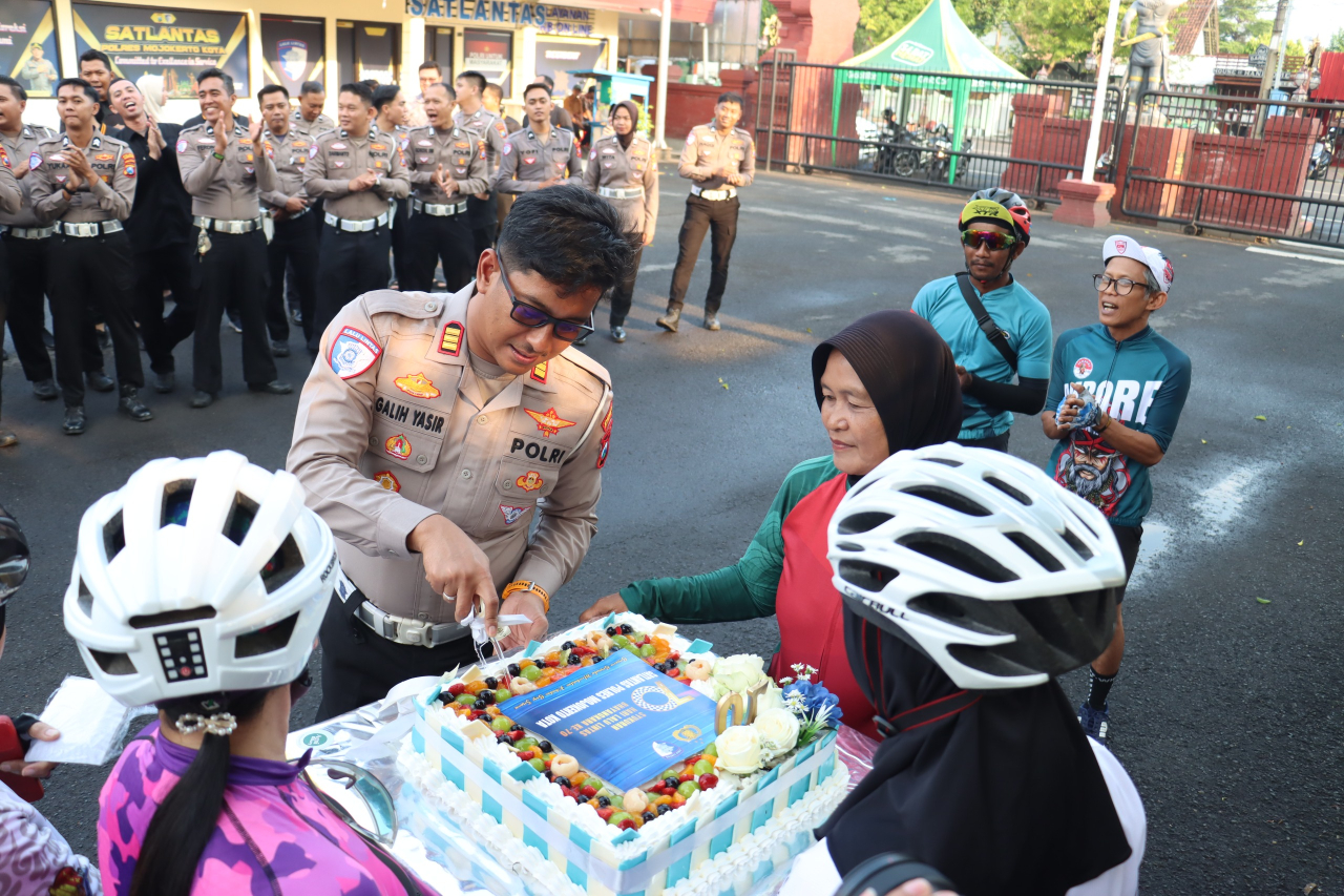 AKP Galih serahkan potongan kue HUT Polantas ke 70, kepada Ketua Komunitas Minitrack Minion Mojokerto (foto ; clara_beritaformat.com)