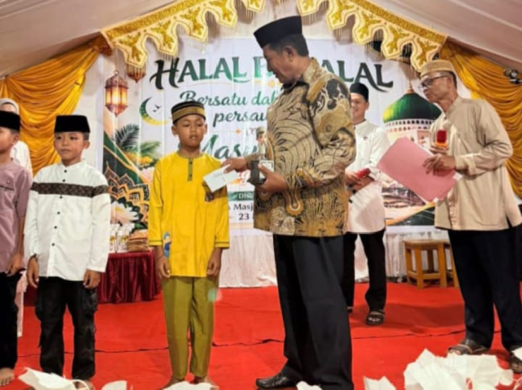 Kepala Desa Tampaure, Agus Latjatja saat memberikan santunan kepada anak-anak Desa Tampaure (foto : anjasman_beritaformat)